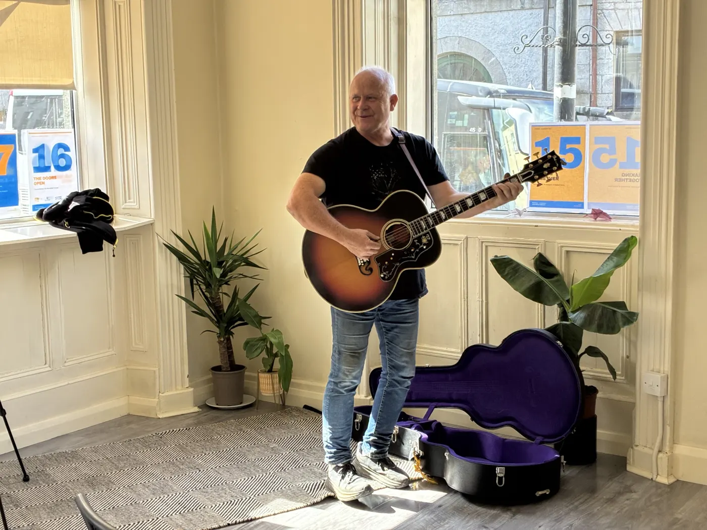 A musician playing guitar at the GAUZE gathering at the Nexus