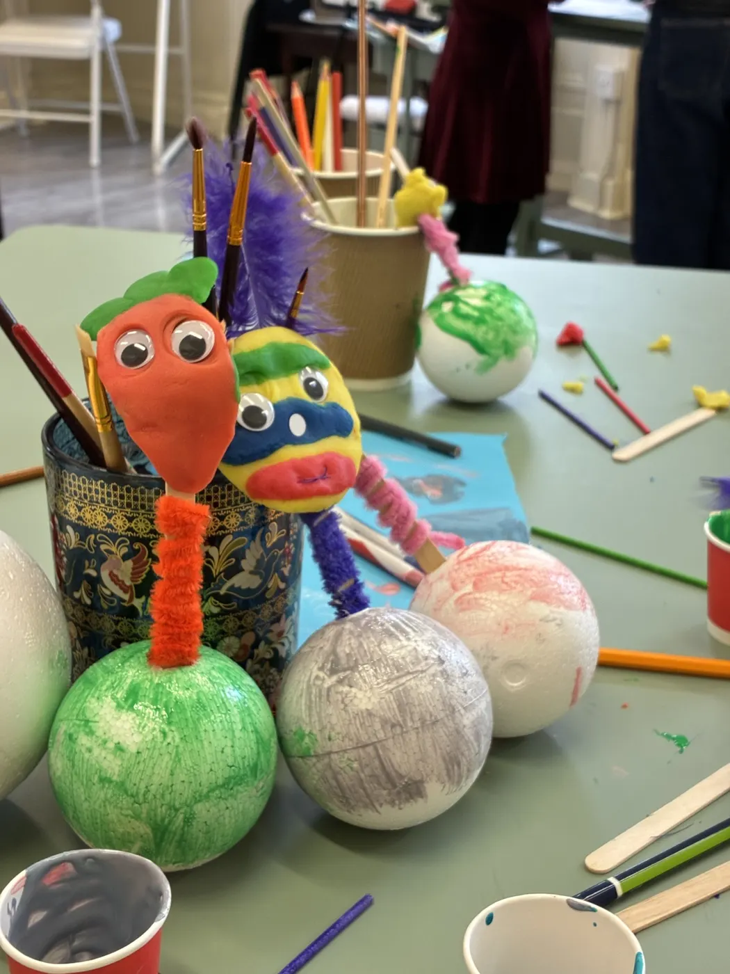 Clay and feather creatures made by children