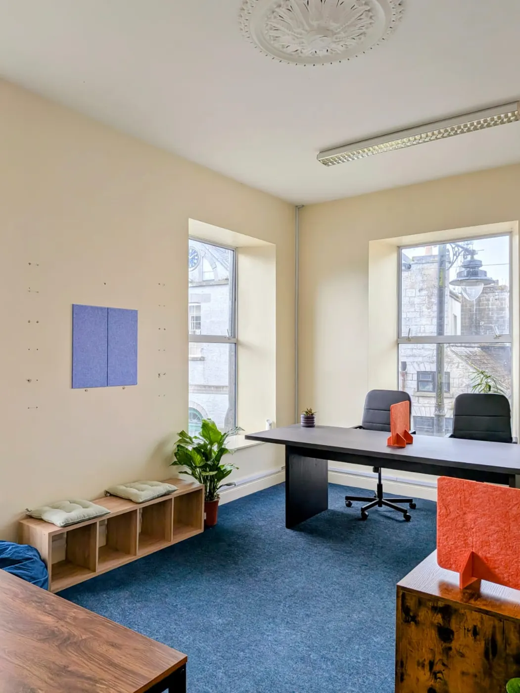 A quiet office room with a wooden desk