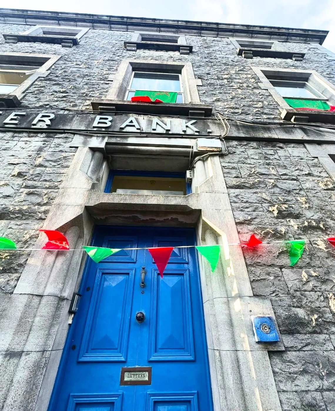 The blue front door of the Nexus with bunting