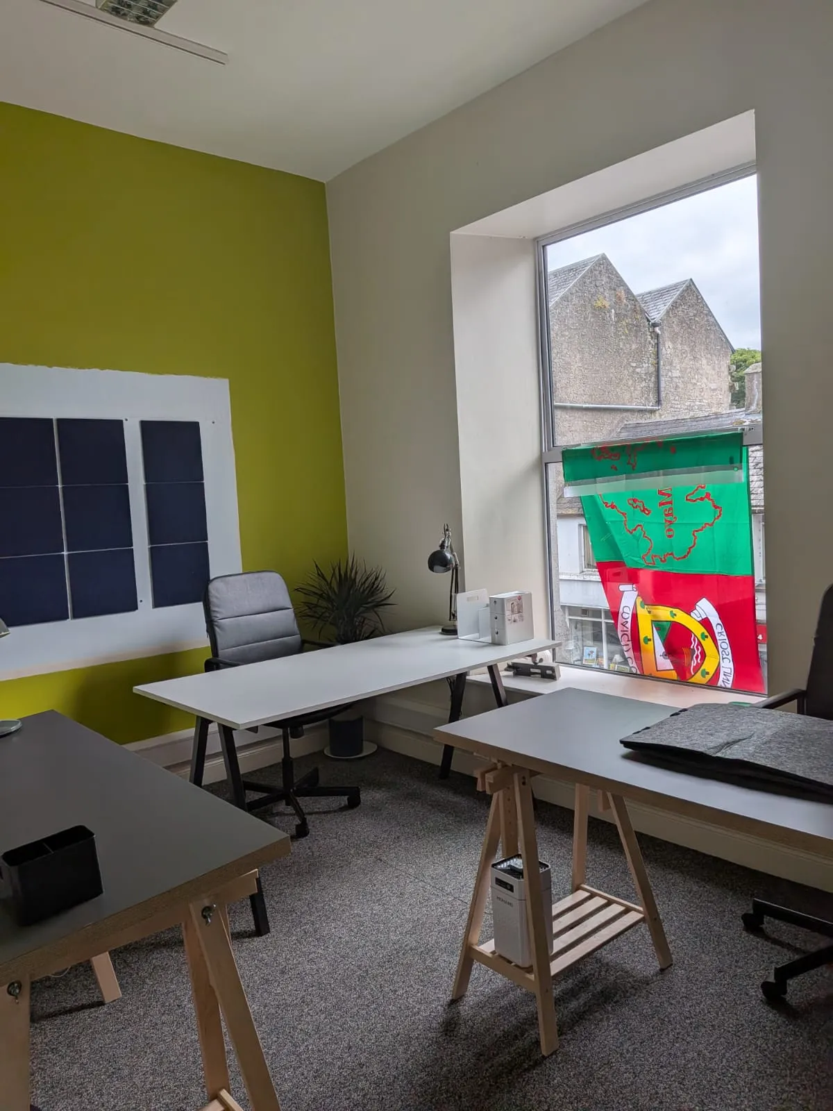 A meeting office with a green feature wall