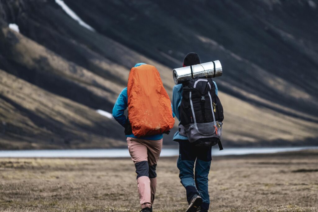 Explorers trekking through stunning Landmannalaugar scenery, Iceland.